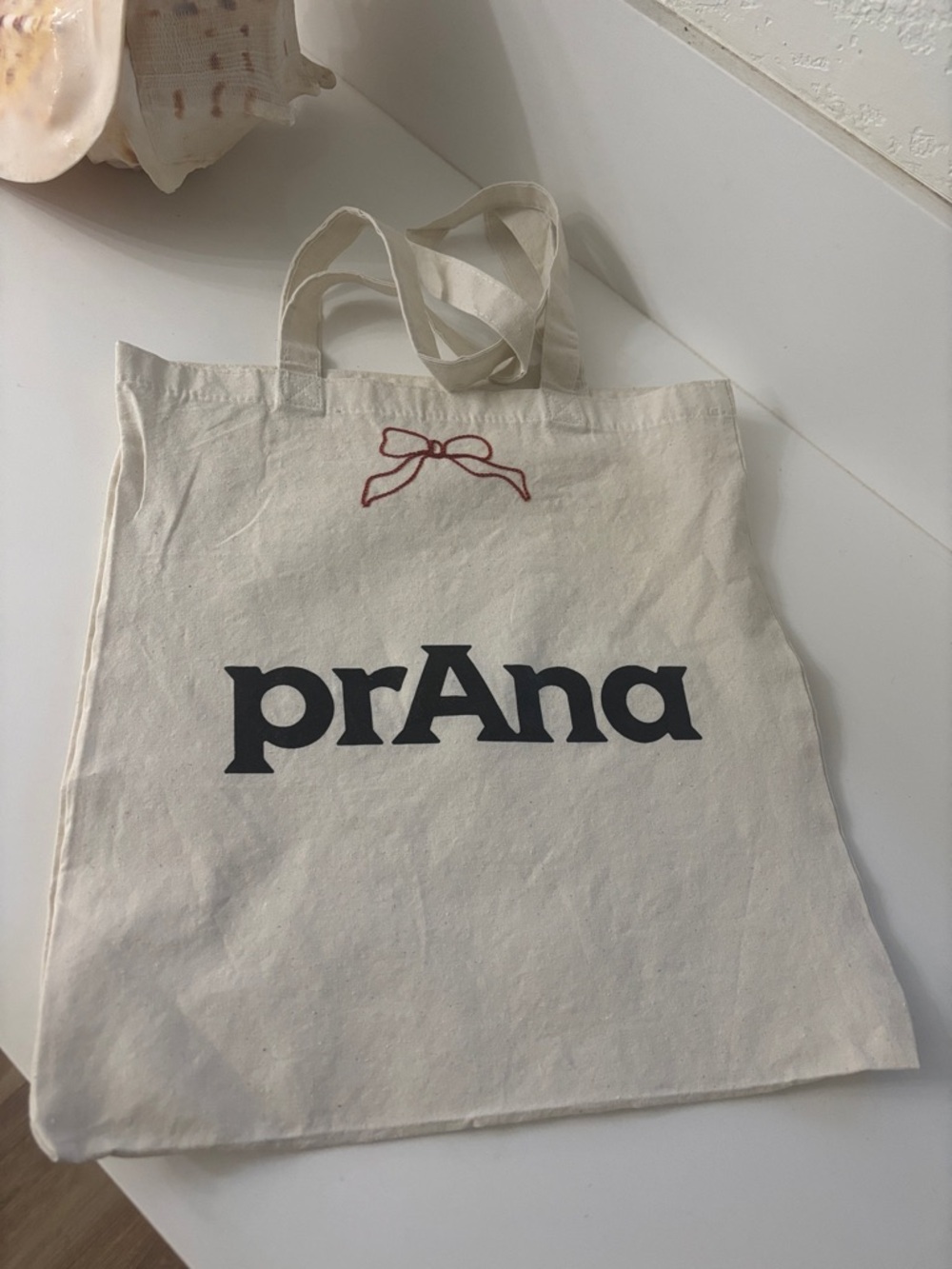 Prana Cream Canvas Tote with Black Logo and Red Bow Accent